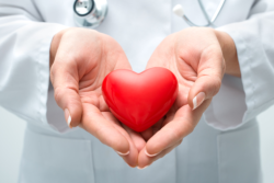 doctor holding a heart shape staff